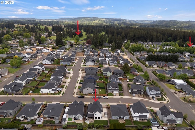 bird's eye view featuring a residential view and a forest view