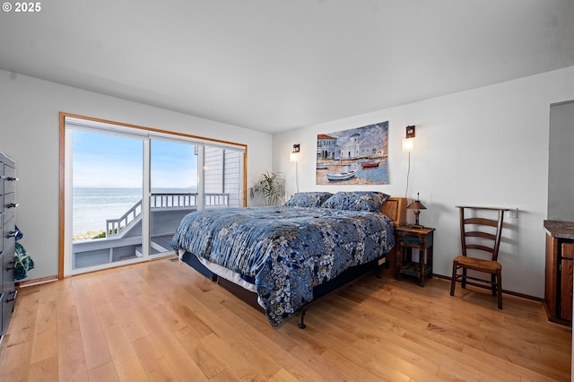 765 5th Ave Unit 5, Hammond, OR 97121 - bedroom featuring access to exterior, light wood finished floors, and a water view
