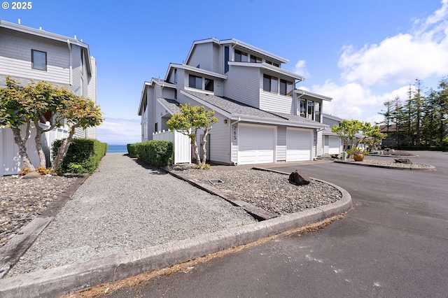765 5th Ave Unit 5, Hammond, OR 97121 - view of front facade with driveway, a garage, and roof with shingles