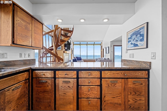 765 5th Ave Unit 5, Hammond, OR 97121 - kitchen featuring brown cabinetry and a peninsula
