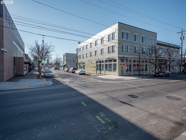 view of street with street lights, curbs, and sidewalks