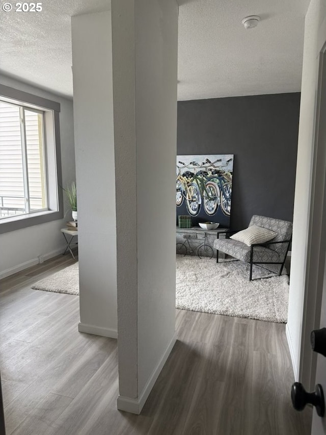 708 N Killingsworth St Unit 7, Portland, OR 97217 - hall with wood finished floors, a textured ceiling, and baseboards