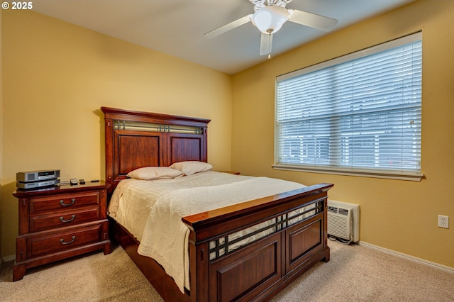 carpeted bedroom featuring ceiling fan and a wall mounted air conditioner