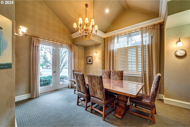 carpeted dining room featuring lofted ceiling, french doors, and a notable chandelier