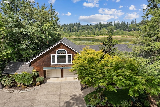 19120 Nixon Ave, West Linn, OR 97068 - view of front of home with driveway, an attached garage, a water view, a wooded view, and roof with shingles