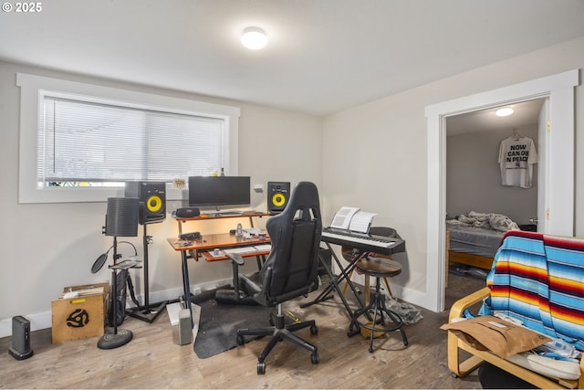 office space featuring baseboards and wood finished floors