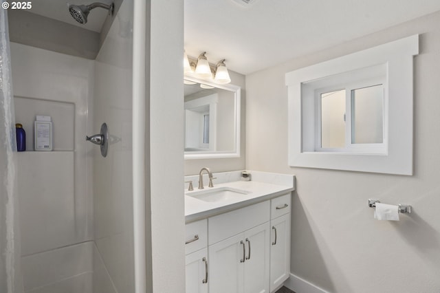 bathroom with a shower and vanity