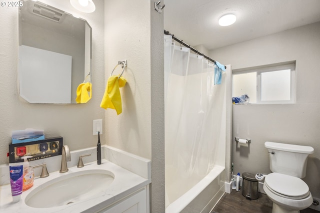 full bathroom featuring shower / bath combination with curtain, visible vents, toilet, vanity, and wood finished floors