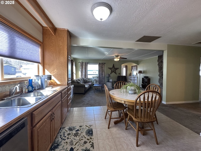 346 N Humbolt St, Canyon City, OR 97820 - dining room featuring light tile patterned flooring, a textured ceiling, light colored carpet, arched walkways, and ceiling fan