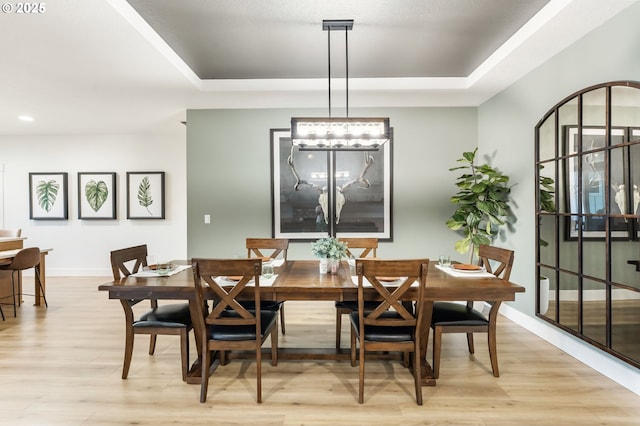 14015 NE 52nd Ave, Vancouver, WA 98686 - dining area with light wood-style flooring, a tray ceiling, baseboards, and a chandelier