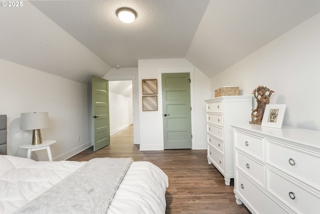14015 NE 52nd Ave, Vancouver, WA 98686 - bedroom featuring vaulted ceiling, dark wood finished floors, a textured ceiling, and baseboards