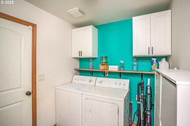 laundry area featuring cabinet space and washing machine and clothes dryer