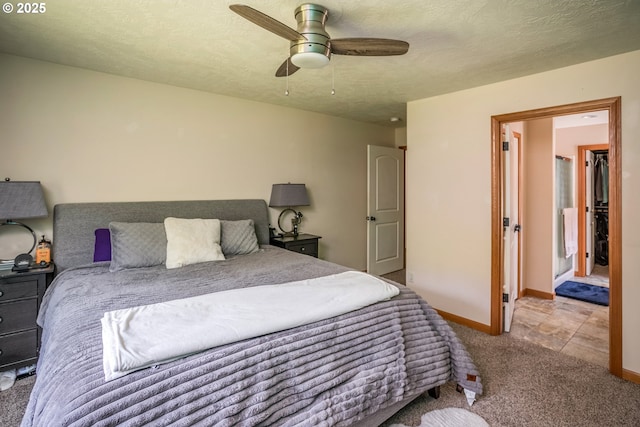 carpeted bedroom featuring baseboards and a ceiling fan