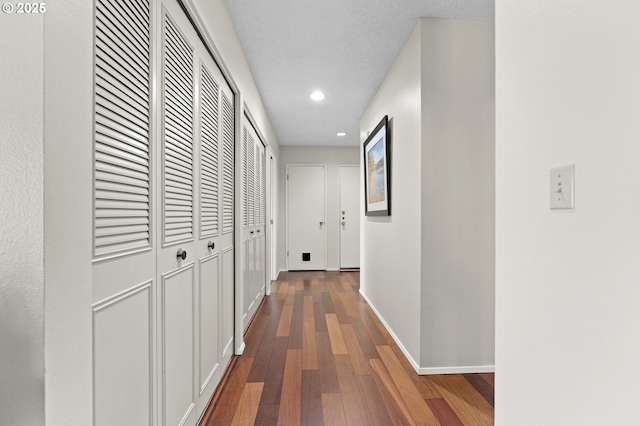 hall with dark wood-type flooring