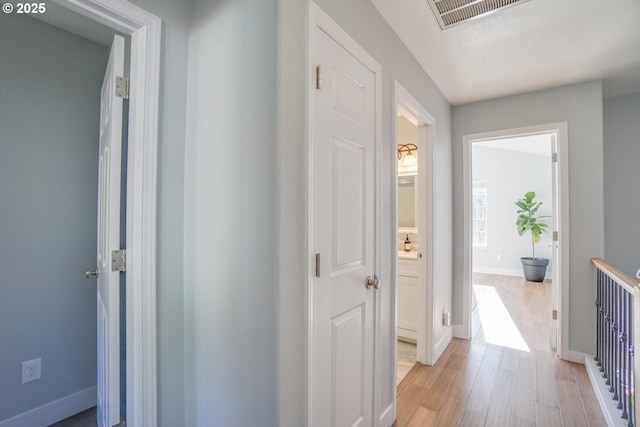 corridor featuring light hardwood / wood-style floors