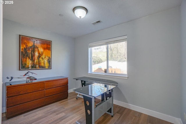 rec room featuring a textured ceiling and light wood-type flooring