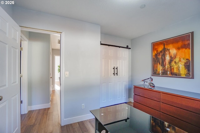 interior space featuring a barn door and light wood-type flooring