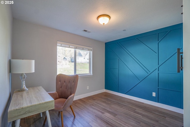 office space with hardwood / wood-style floors and a textured ceiling