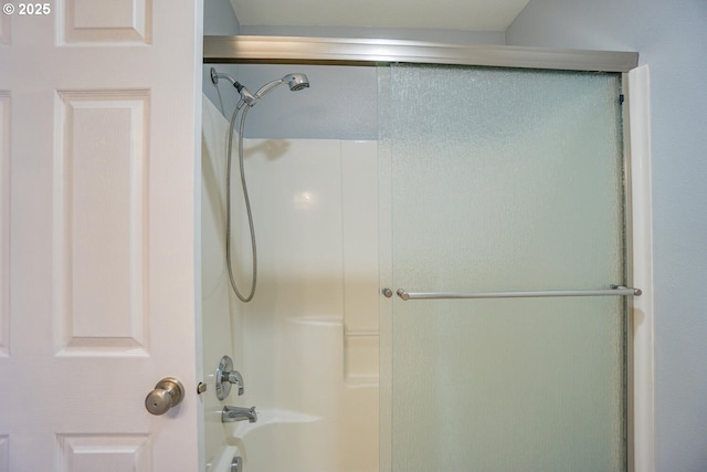 bathroom featuring shower / bath combination with glass door