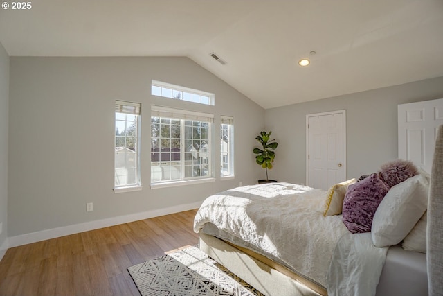 bedroom with lofted ceiling and hardwood / wood-style floors