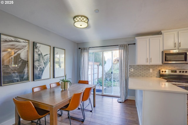 dining room with dark hardwood / wood-style flooring