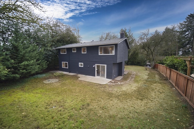 rear view of house with a patio area and a lawn