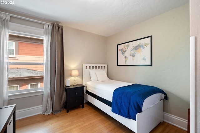 233 SE 28th Ave, Portland, OR 97214 - bedroom with light wood-style floors, baseboards, and a textured ceiling