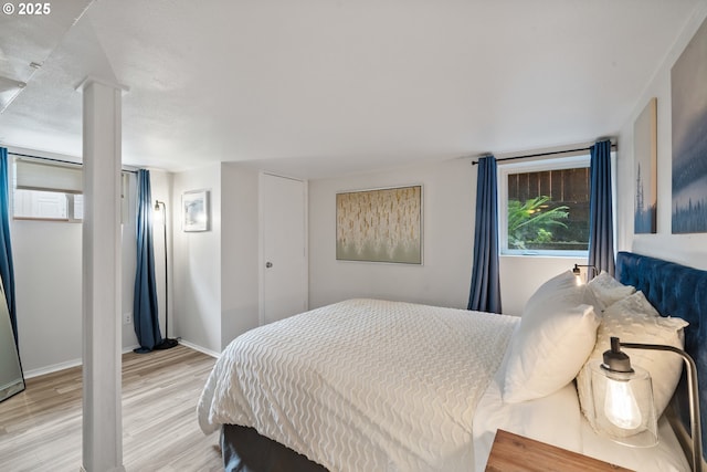 233 SE 28th Ave, Portland, OR 97214 - bedroom with light wood-style flooring and baseboards