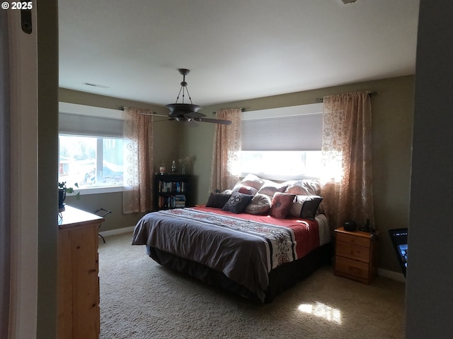 carpeted bedroom with visible vents and baseboards