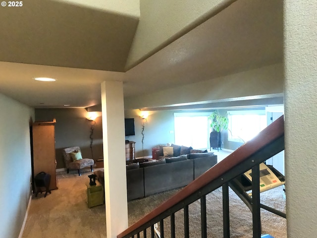 living room featuring carpet flooring and vaulted ceiling