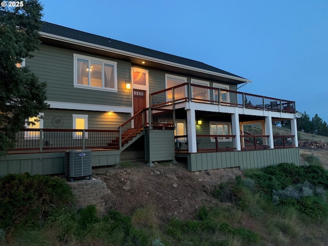 rear view of house featuring stairs, a deck, and cooling unit