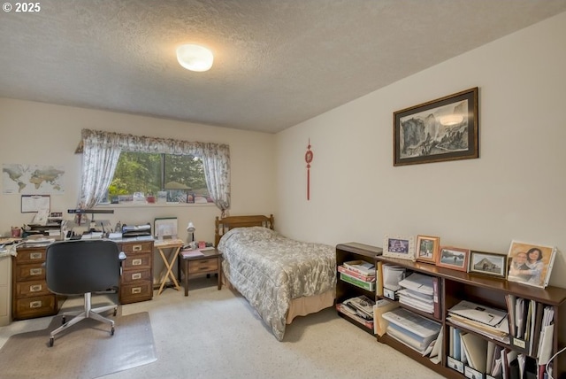 bedroom featuring light carpet, a textured ceiling, and an office area
