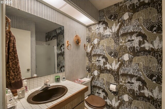 bathroom featuring wallpapered walls, vanity, toilet, and tile patterned flooring