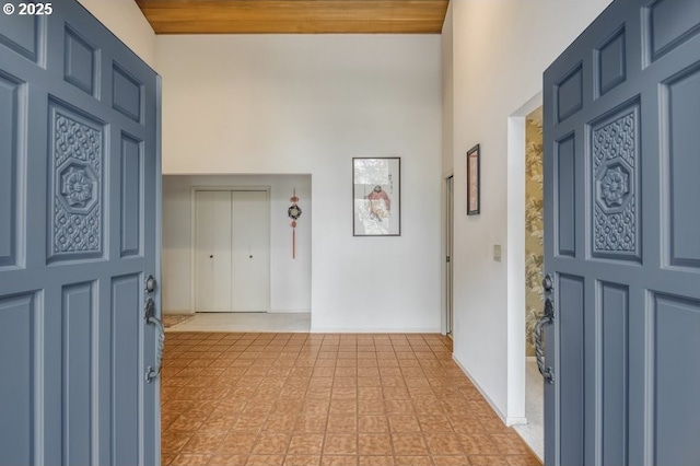 entrance foyer with a high ceiling and baseboards