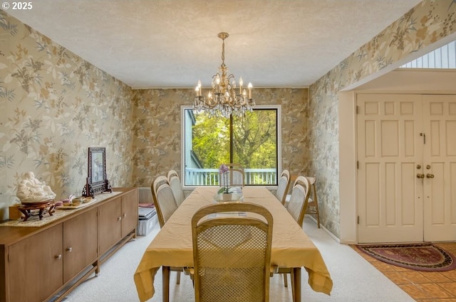 dining space with a chandelier and wallpapered walls