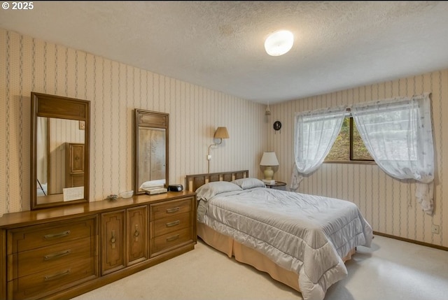 bedroom with light carpet, wallpapered walls, a textured ceiling, and baseboards