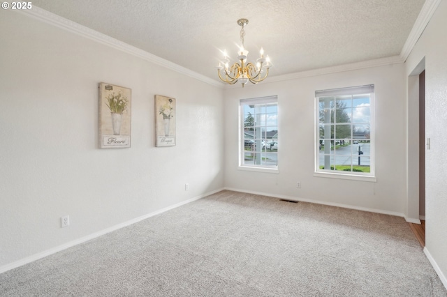 spare room with a chandelier, a textured ceiling, carpet floors, visible vents, and crown molding