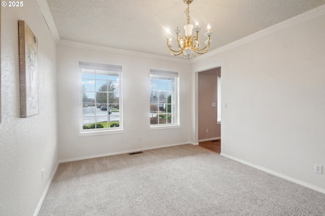 unfurnished room with a textured ceiling, a notable chandelier, carpet floors, visible vents, and ornamental molding