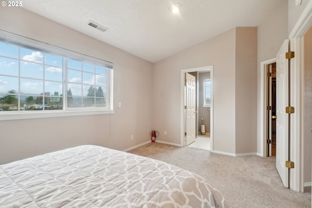 unfurnished bedroom featuring carpet, visible vents, vaulted ceiling, and baseboards