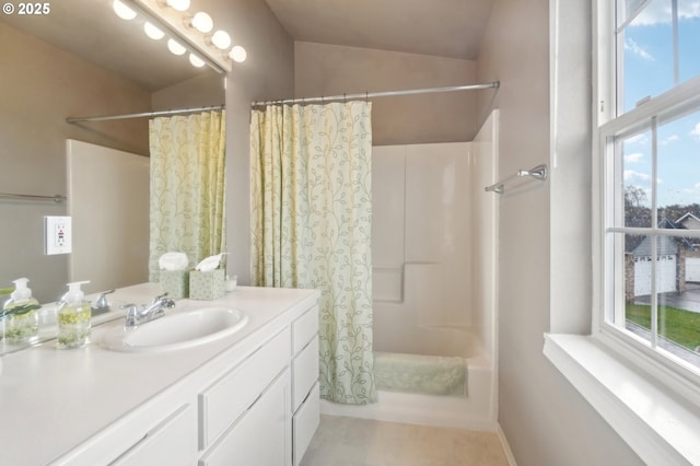 bathroom featuring shower / bath combo, vaulted ceiling, and vanity