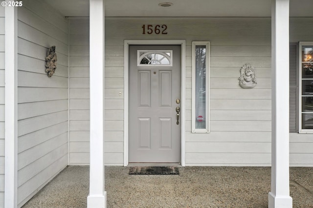 view of exterior entry featuring a porch