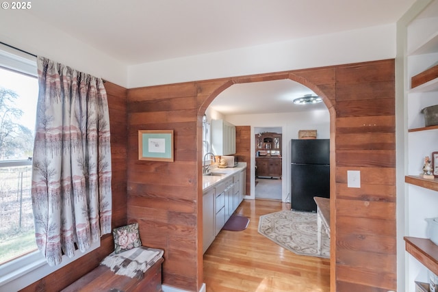 bathroom with vanity, wood walls, and hardwood / wood-style floors