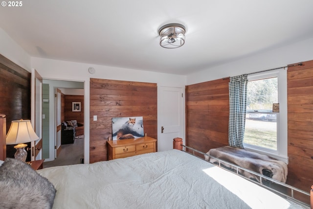 bedroom featuring wooden walls