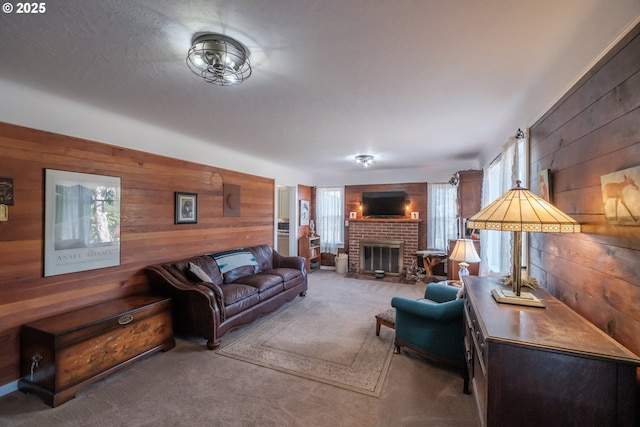 carpeted living room with a brick fireplace and wood walls