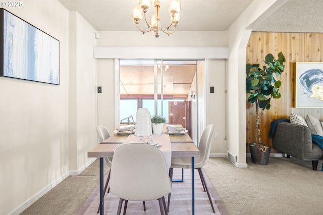 1422 NE 57th Ave, Portland, OR 97213 - dining area featuring carpet flooring, a chandelier, and wood walls