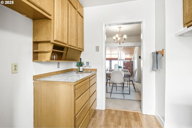 1422 NE 57th Ave, Portland, OR 97213 - kitchen featuring light wood finished floors, a chandelier, open shelves, and light countertops