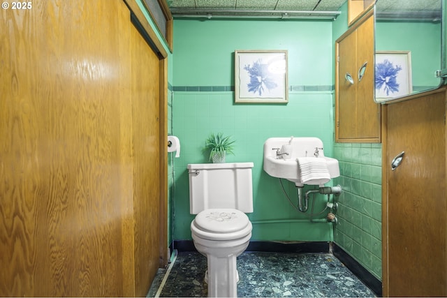 1422 NE 57th Ave, Portland, OR 97213 - half bathroom featuring a wainscoted wall and tile walls