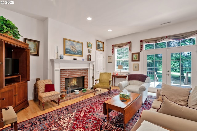 83485 Clear Lake Rd, Florence, OR 97439 - living area with light wood-style flooring, french doors, a brick fireplace, and recessed lighting
