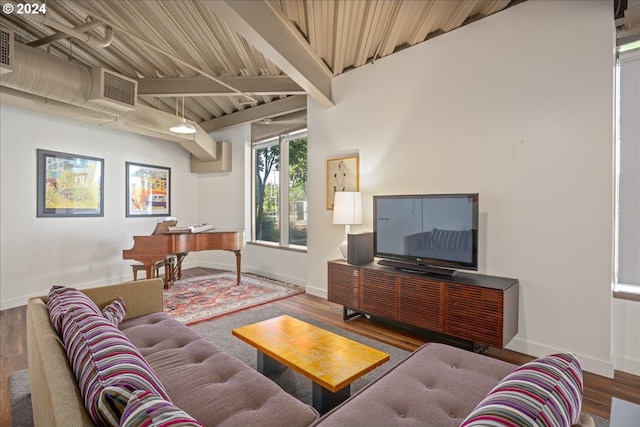 living room with wood-type flooring and vaulted ceiling with beams