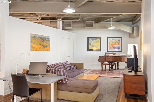 office area with beam ceiling and hardwood / wood-style floors